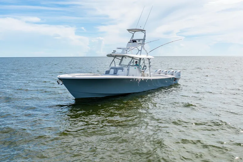 Slide: The Image of 2018 Regulator 41 boat on open water under a clear sky. - 8