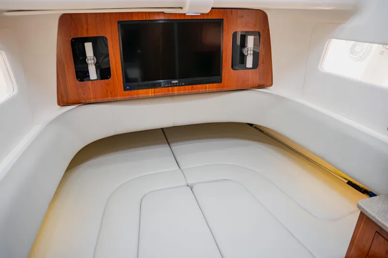 Slide: The Image of 2018 Regulator 41 cabin interior with TV and white seating. - 82