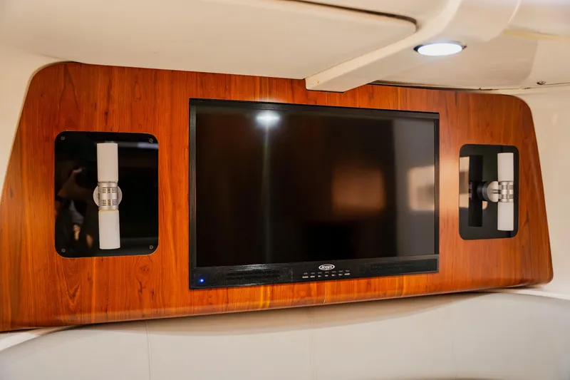 Slide: The Image of Entertainment system on 2018 Regulator 41 boat, featuring a wall-mounted TV and modern lighting. - 83