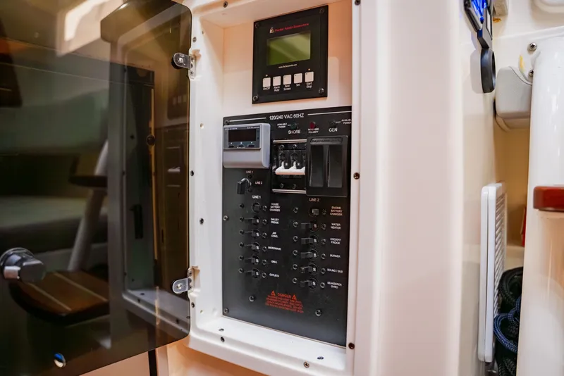 Slide: The Image of Electrical panel inside a 2018 Regulator 41 boat, showcasing switches and controls. - 88