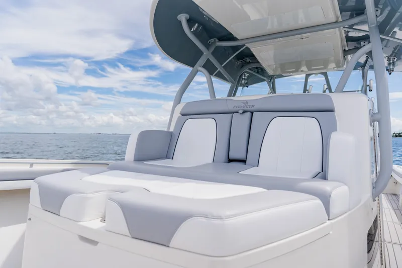 Slide: The Image of 2018 Regulator 41 boat with luxurious seating, ocean backdrop, and clear sky. - 94