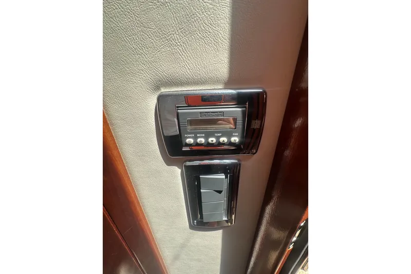 Slide: The Image of Control panel inside 2010 Meridian 391 Sedan, featuring temperature and fan settings. - 13