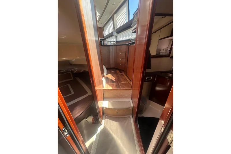 Slide: The Image of Interior of 2010 Meridian 391 Sedan yacht with wood finishes and cozy cabin spaces. - 14