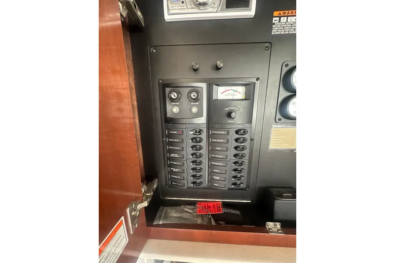 Slide: The Image of Electrical panel inside a 2010 Meridian 391 Sedan boat, featuring various switches and gauges. - 18