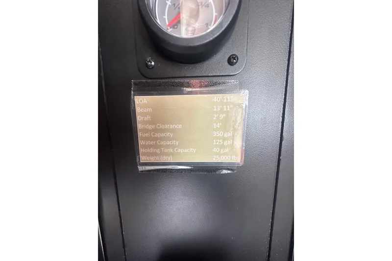 Slide: The Image of 2010 Meridian 391 Sedan specifications plaque with gauge, showing dimensions and capacities. - 19