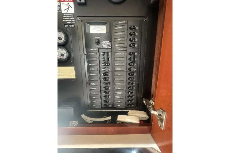 Slide: The Image of Electrical panel inside a 2010 Meridian 391 Sedan boat, featuring labeled switches and gauges. - 20