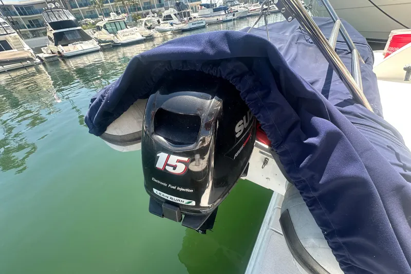 Slide: The Image of Outboard motor on a 2010 Meridian 391 Sedan, docked in a marina. - 24