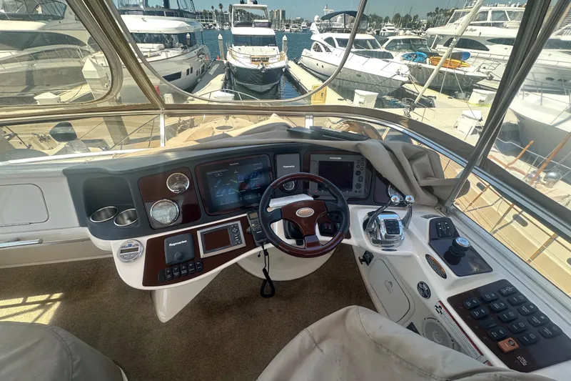 Slide: The Image of 2010 Meridian 391 Sedan helm with navigation controls, docked at marina with yachts. - 27