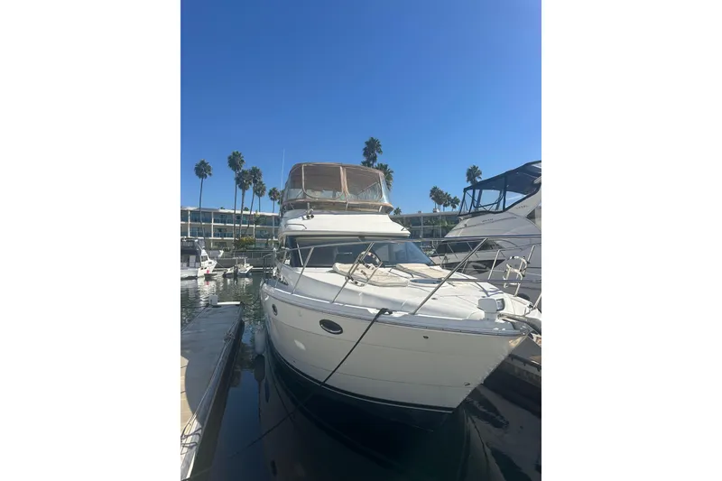 Slide: The Image of 2010 Meridian 391 Sedan yacht docked in marina under clear blue sky. - 3