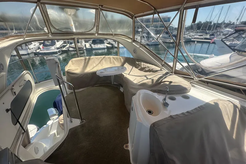 Slide: The Image of 2010 Meridian 391 Sedan yacht interior with covered seating and marina view. - 32