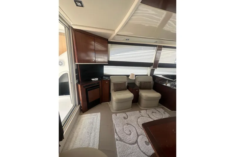 Slide: The Image of Interior of 2010 Meridian 391 Sedan yacht with plush seating and elegant wood cabinetry. - 5
