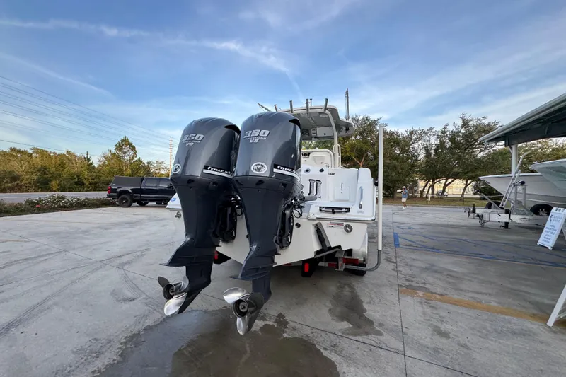 Slide: The Image of 2008 Everglades 290 Center Console boat with twin 350 V8 engines, parked outdoors. - 12