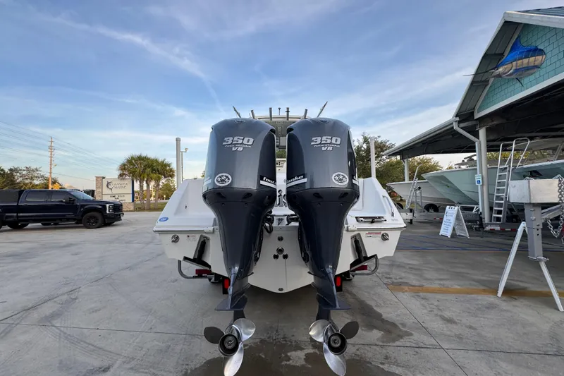 Slide: The Image of 2008 Everglades 290 Center Console with twin 350 V8 outboard engines at a marina. - 13