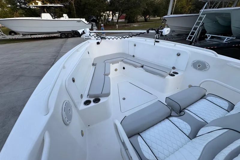 Slide: The Image of 2008 Everglades 290 Center Console boat interior with cushioned seating and cup holders. - 19