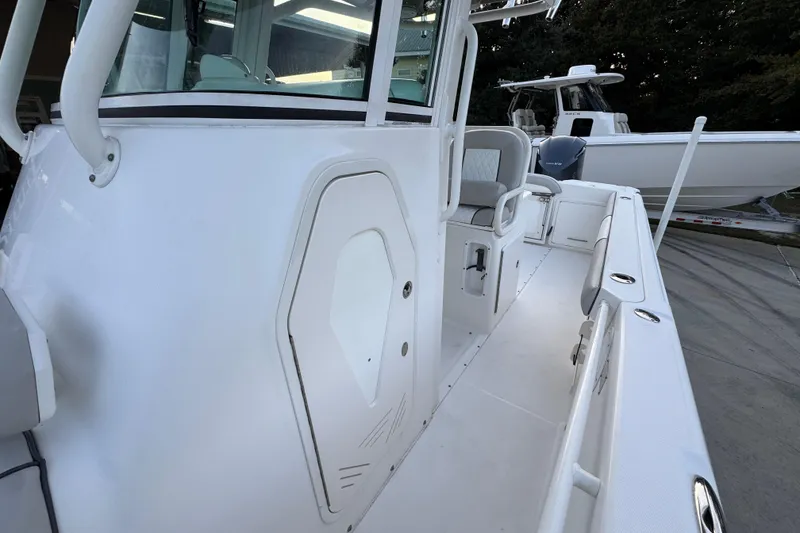 Slide: The Image of 2008 Everglades 290 Center Console boat interior with seating and storage compartments. - 26