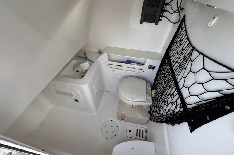 Slide: The Image of Interior of 2008 Everglades 290 Center Console boat with compact bathroom amenities. - 28