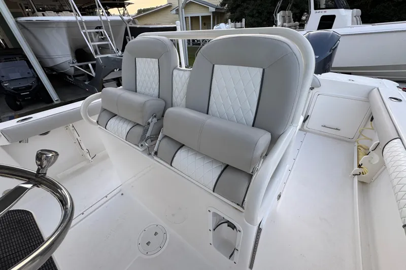 Slide: The Image of 2008 Everglades 290 Center Console boat with dual cushioned seats and steering wheel. - 30