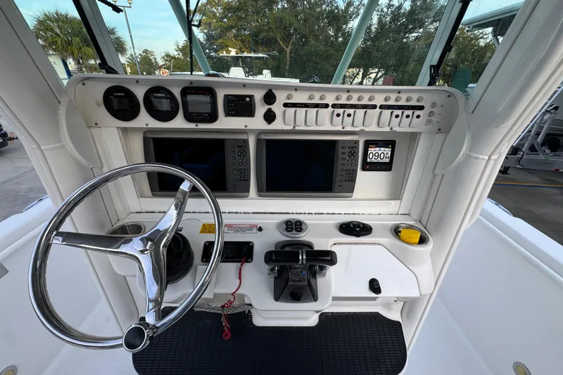 Slide: The Image of 2008 Everglades 290 Center Console boat dashboard with steering wheel and navigation controls. - 34