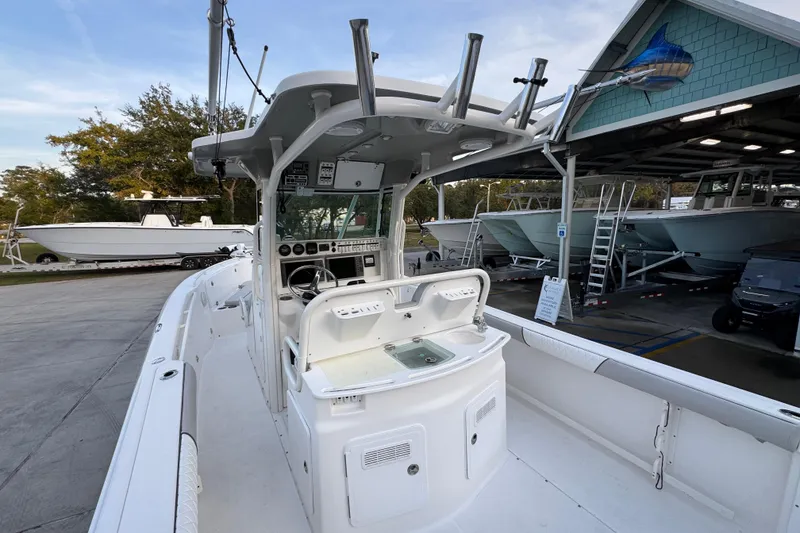 Slide: The Image of 2008 Everglades 290 Center Console boat at marina, showcasing helm and seating area. - 38