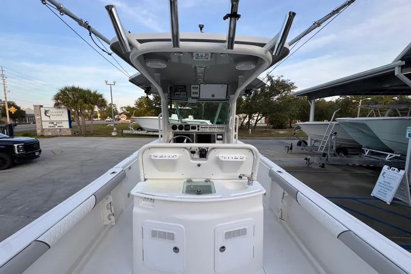 Slide: The Image of 2008 Everglades 290 Center Console boat at marina, showcasing helm and seating area. - 39