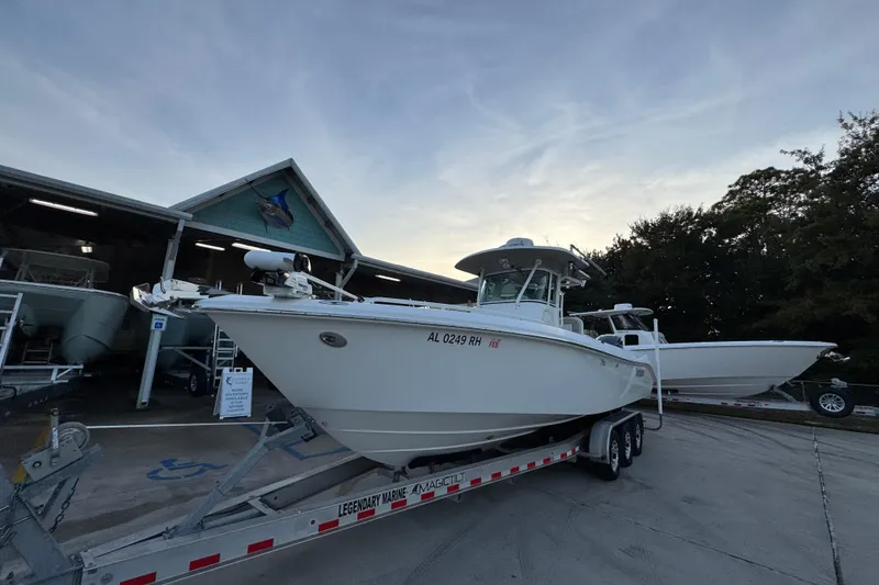 Slide: The Image of 2008 Everglades 290 Center Console boat on trailer at marina, sunset background. - 4