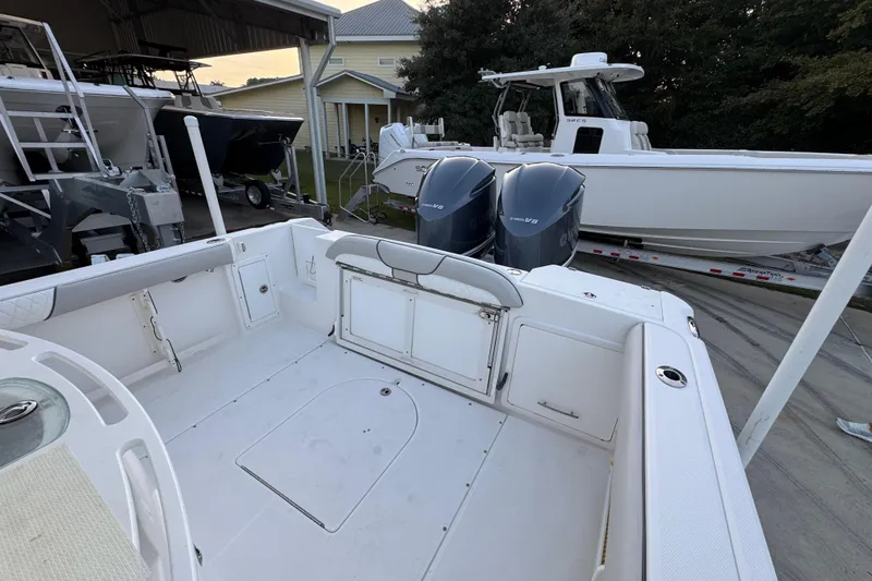 Slide: The Image of 2008 Everglades 290 Center Console boat with twin Yamaha V8 engines in a marina. - 41