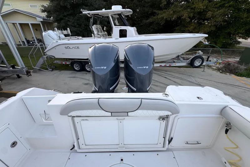 Slide: The Image of 2008 Everglades 290 Center Console with dual Yamaha V8 engines, parked near a Solace boat. - 42