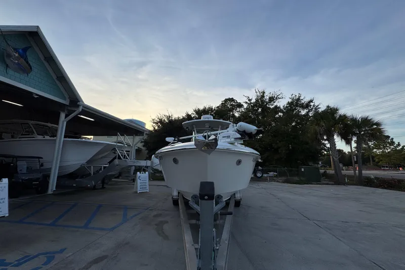 Slide: The Image of 2008 Everglades 290 Center Console boat on trailer at marina during sunset. - 6