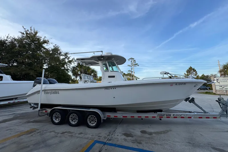 Slide: The Image of 2008 Everglades 290 Center Console boat on trailer, parked outdoors under clear sky. - 9