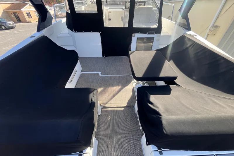 Slide: The Image of 2018 Cruisers Yachts 390 Express Coupe interior with black seating covers and carpeted floor. - 12