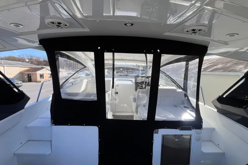 Slide: The Image of 2018 Cruisers Yachts 390 Express Coupe interior with black canopy and seating area. - 13