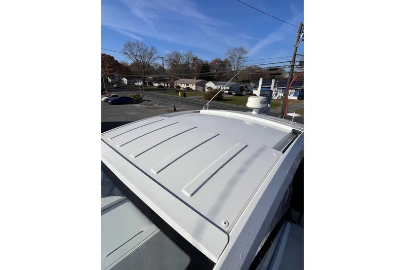 Slide: The Image of 2018 Cruisers Yachts 390 Express Coupe rooftop view under clear blue sky. - 2