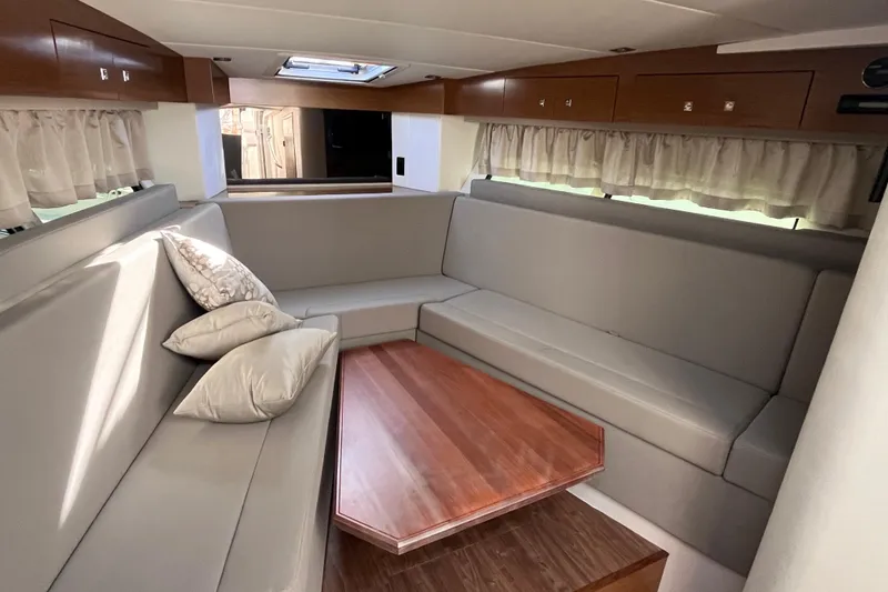 Slide: The Image of Luxurious interior of 2018 Cruisers Yachts 390 Express Coupe with plush seating and wooden table. - 4