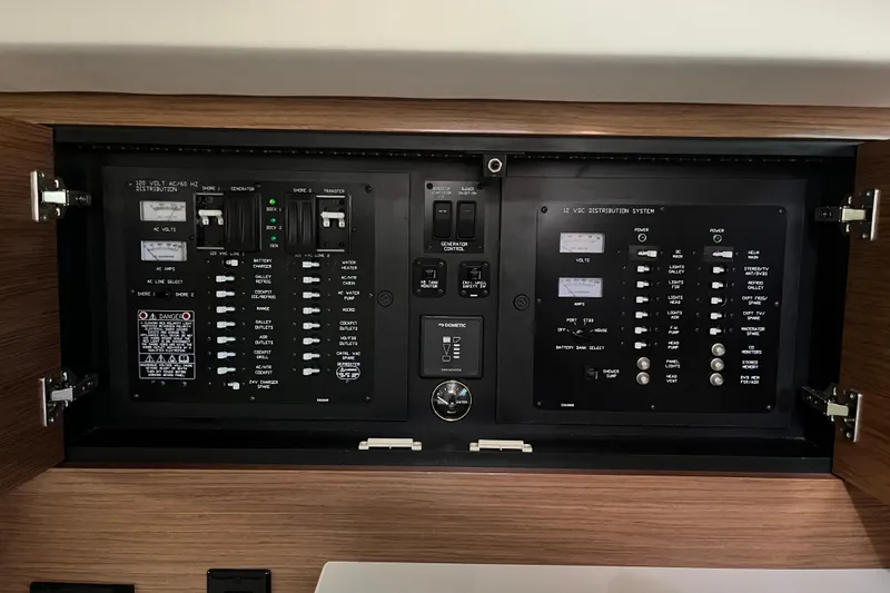 Slide: The Image of Electrical control panel of 2018 Cruisers Yachts 390 Express Coupe, featuring various switches and indicators. - 9