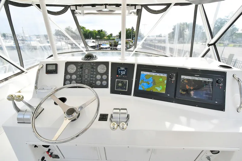 Slide: The Image of Cockpit of 1997 Viking 47 Convertible yacht with navigation instruments and steering wheel. - 11