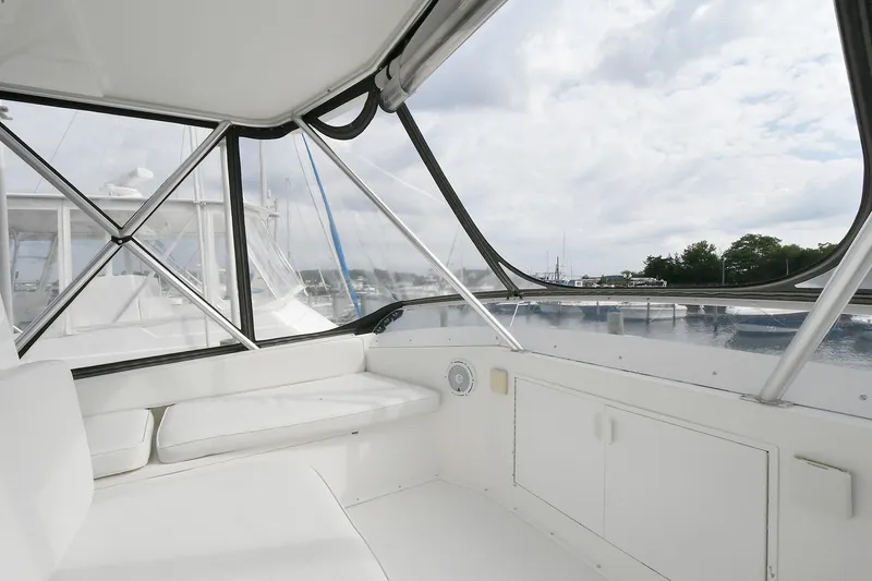 Slide: The Image of Interior view of 1997 Viking 47 Convertible yacht with white seating and windows. - 14
