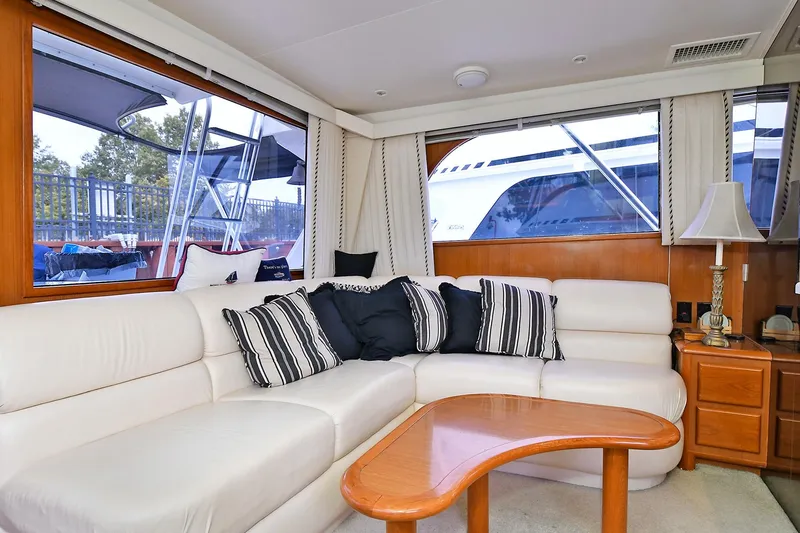 Slide: The Image of Luxurious interior of a 1997 Viking 47 Convertible yacht with white leather seating. - 16