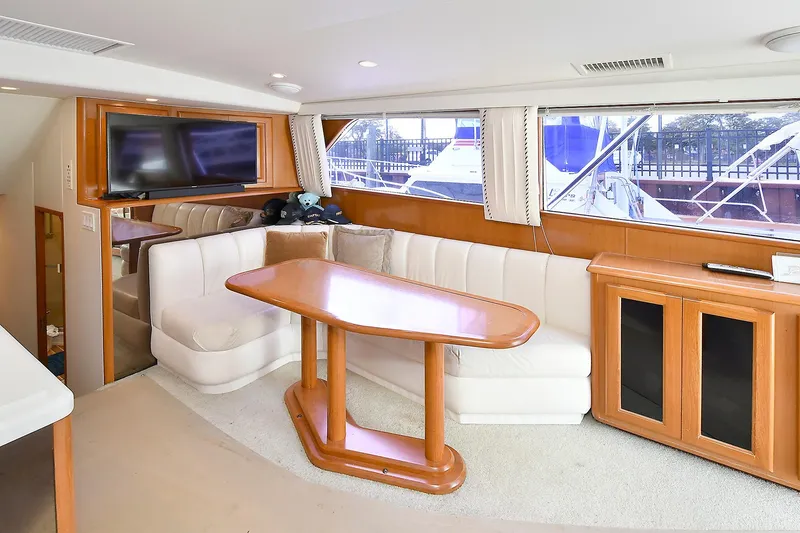 Slide: The Image of Interior of 1997 Viking 47 Convertible yacht with dining area and large windows. - 22