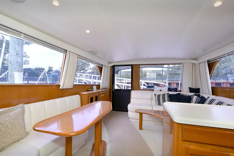 Slide: The Image of Luxurious interior of a 1997 Viking 47 Convertible yacht with elegant seating and wooden accents. - 24