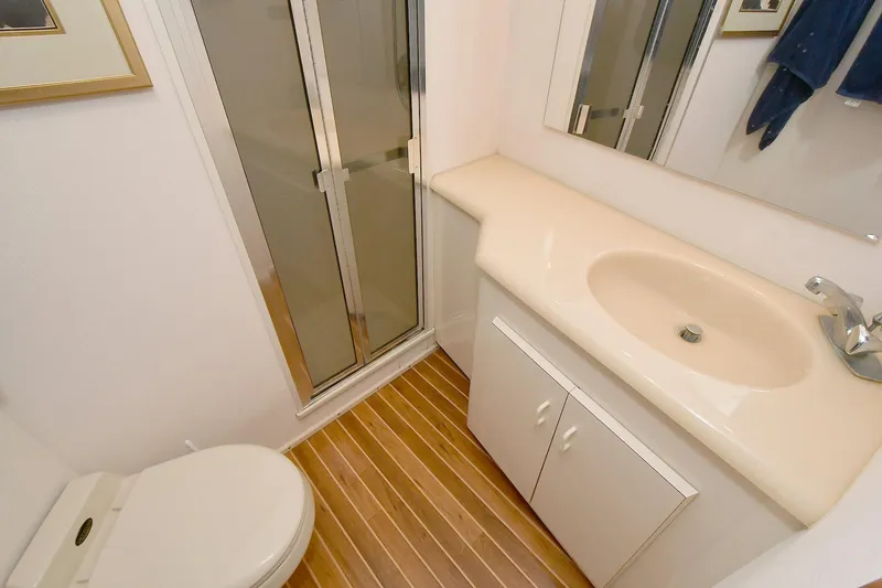 Slide: The Image of Bathroom interior of 1997 Viking 47 Convertible yacht with shower, sink, and toilet. - 28