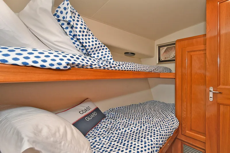 Slide: The Image of Bunk beds with polka dot bedding in a 1997 Viking 47 Convertible yacht cabin. - 29