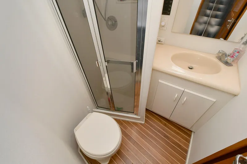 Slide: The Image of Bathroom in 1997 Viking 47 Convertible yacht with shower, toilet, and sink. - 30