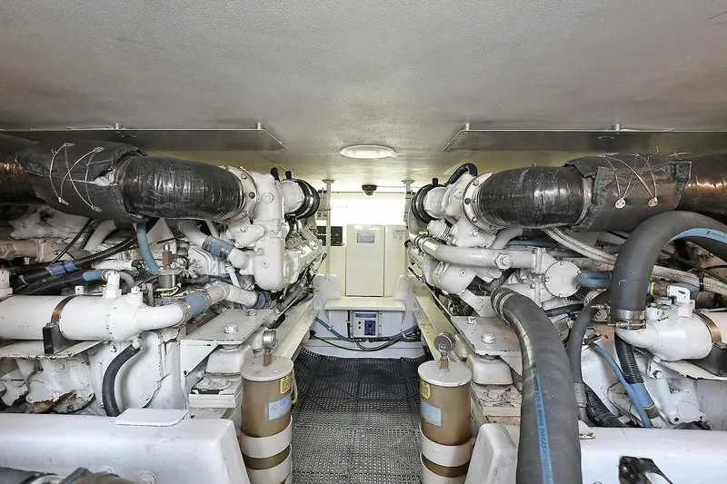 Slide: The Image of Engine room of 1997 Viking 47 Convertible yacht, showcasing dual engines and mechanical systems. - 34
