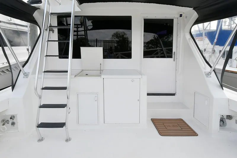 Slide: The Image of 1997 Viking 47 Convertible yacht deck with ladder and storage cabinets. - 6