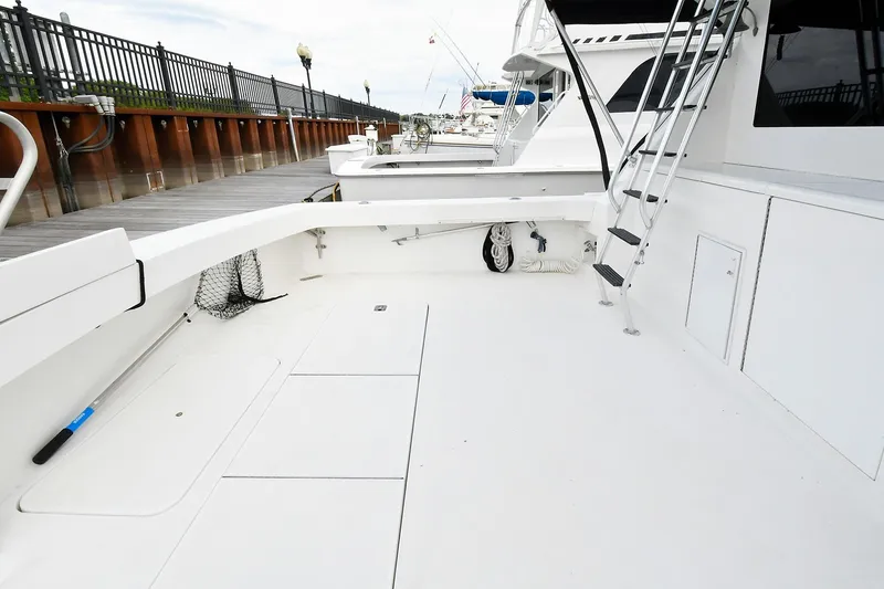 Slide: The Image of 1997 Viking 47 Convertible yacht deck with ladder and dockside view. - 7