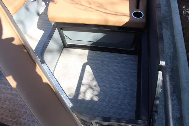 Slide: The Image of Interior of 2026 Starcraft SLS 3 RL boat with tan seating and cup holder. - 10