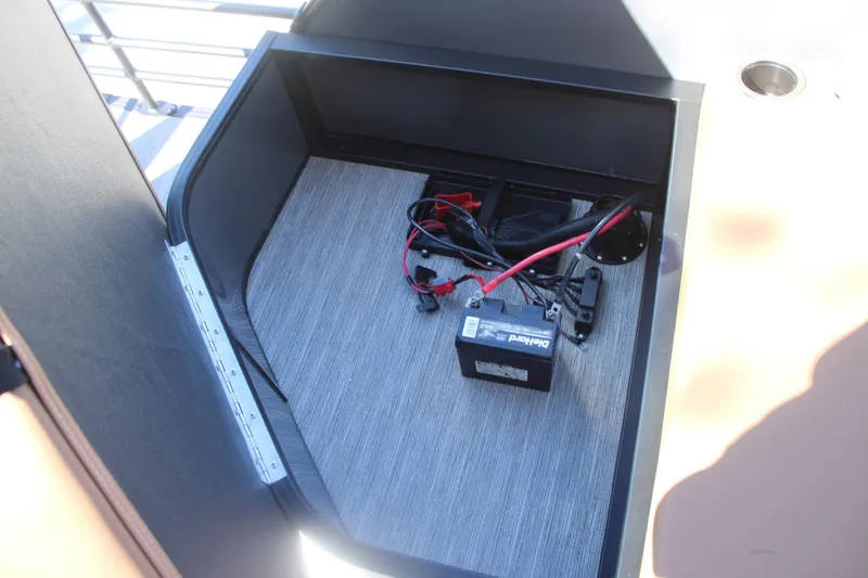 Slide: The Image of Battery compartment of 2026 Starcraft SLS 3 RL with wiring and storage space. - 11