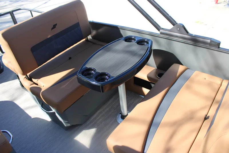 Slide: The Image of 2026 Starcraft SLS 3 RL boat interior with tan seating and a central table. - 12