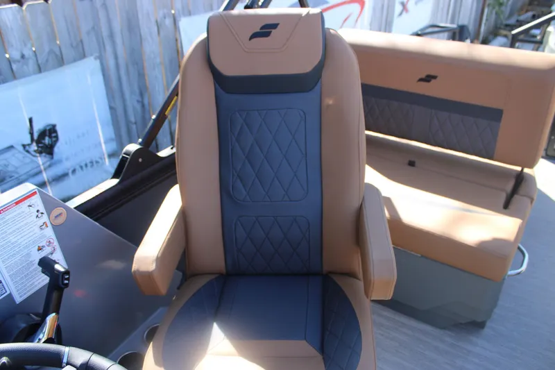 Slide: The Image of Captain's chair in 2026 Starcraft SLS 3 RL boat, featuring tan and blue upholstery. - 17