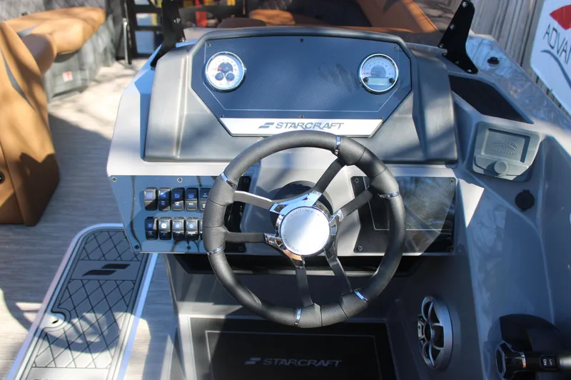Slide: The Image of 2026 Starcraft SLS 3 RL boat dashboard with steering wheel and control panel. - 18